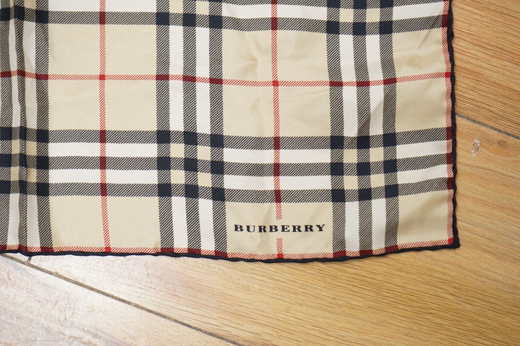Three silk scarves comprising a Burberry check example, Christian Dior monogrammed and a Vakko abstract patterned example